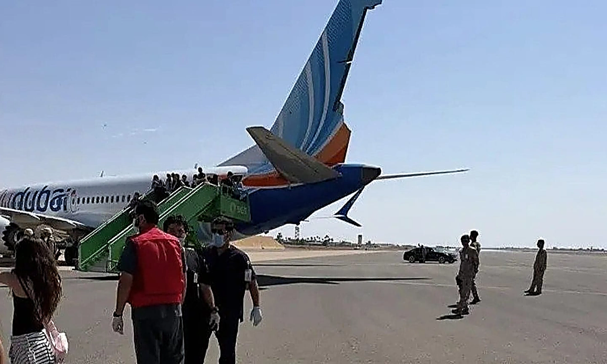 تبوک ایئرپورٹ پر ہنگامی لینڈنگ کے بعد فلائی دبئی کا طیارہ اور سکیورٹی اہلکار