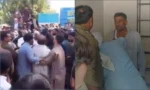 اکمل کی دکان کے اندر پولیس اہلکاروں سے بحث کا منظر، دوسری جانب مظاہرین نے سڑک بلاک کر رکھی ہے